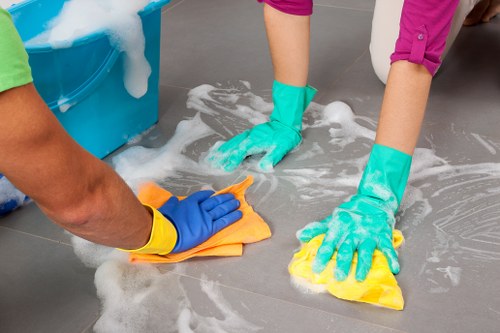 Professional carpet cleaner in W2 deep cleaning a living room carpet