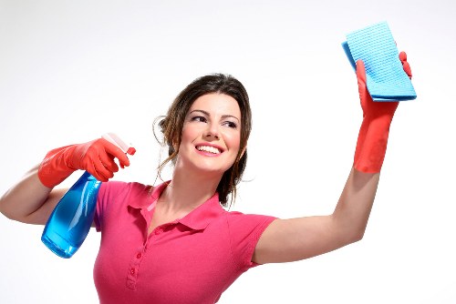 Cleaner using tools for window cleaning in W2 on a London building